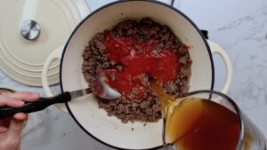 step 2. add tomato sauce, beef broth