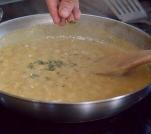 step 6. add sauce to pan with herbs