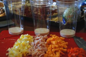 for the perfect salad cup, the dressing goes on the bottom
