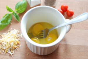 step one - beat the eggs in the mug