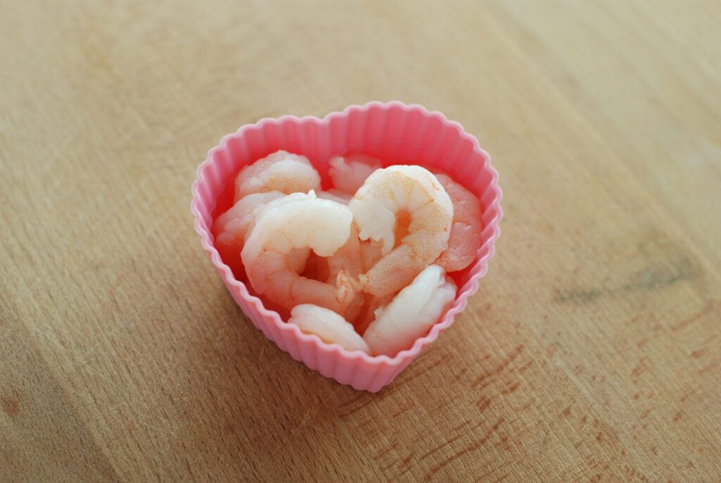This is a picture of pink shrimp in a heart shaped cup. Read more at beneficial-bento.com
