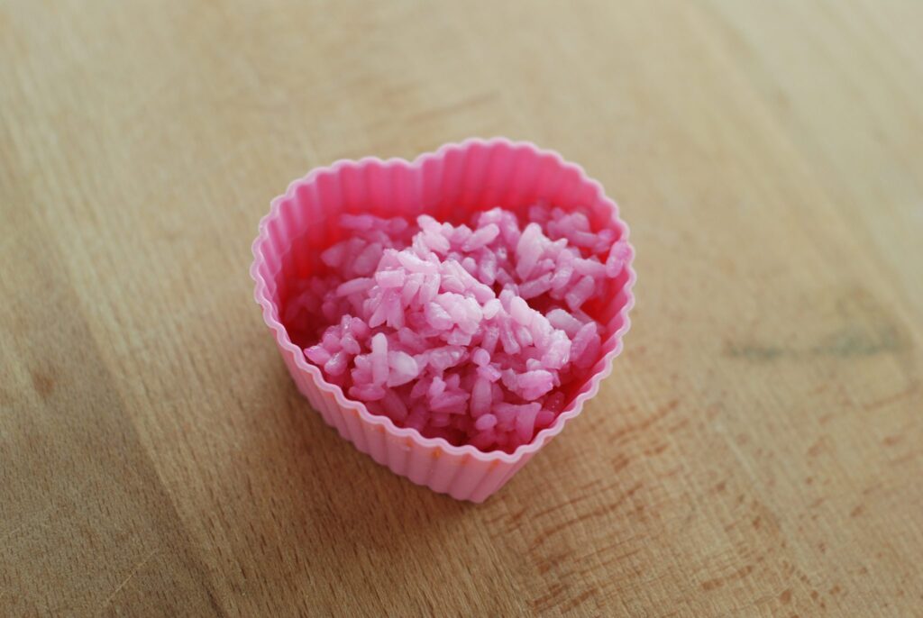 This is a picture of rice that has been tinted pink with beet juice. Read more at beneficial-bento.com