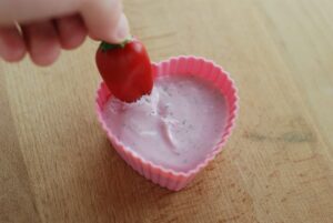 This is a picture of veggie dip that has been tinted pink with beet juice. Read more at beneficial-bento.com