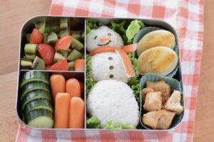 this is a picture of a snowman rice ball bento, recipe at benenficial-bento.com