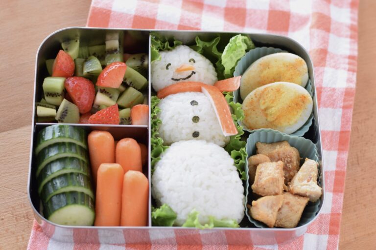 this is a picture of a snowman rice ball bento, recipe at benenficial-bento.com