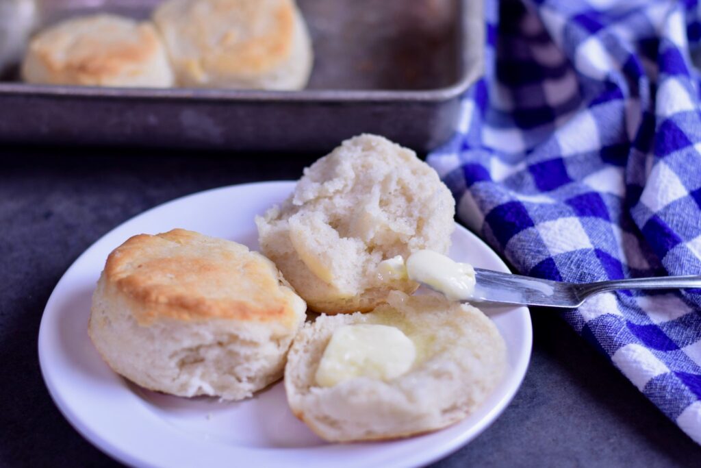 Homemade gluten free biscuits, split open and spread with butter.  From my free ebook, Gluten Free Baking for Beginners.