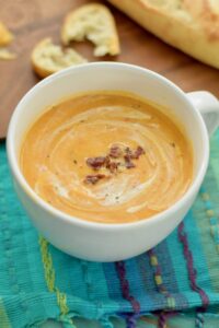 Roasted Butternut and Red Pepper Soup topped with crumbled bacon, horizontal view