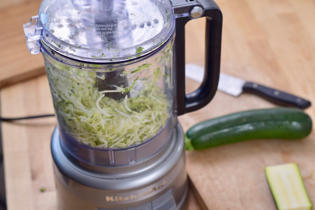 Step 4. Shred zucchini, use food processor for best results.