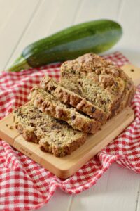 zucchini bread with a zucchini in background