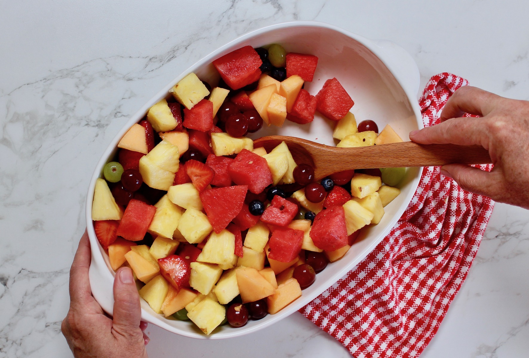 toss fruit in large bowl