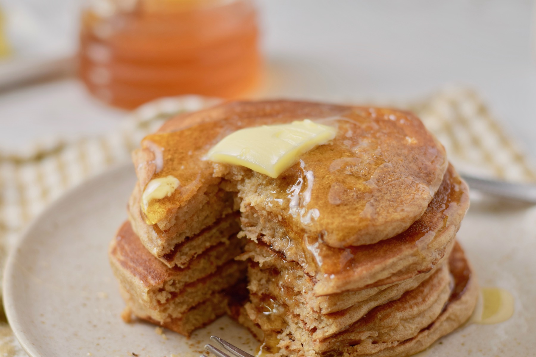 gf honey oat pancakes with bite, wide