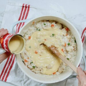 adding soup to chicken and rice