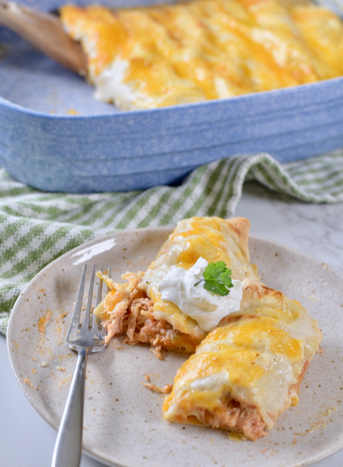 chicken enchiladas, sour cream and cilantro