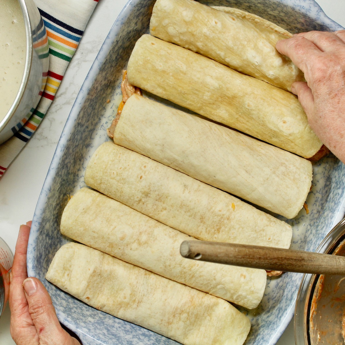 step 7. roll up and fill baking dish