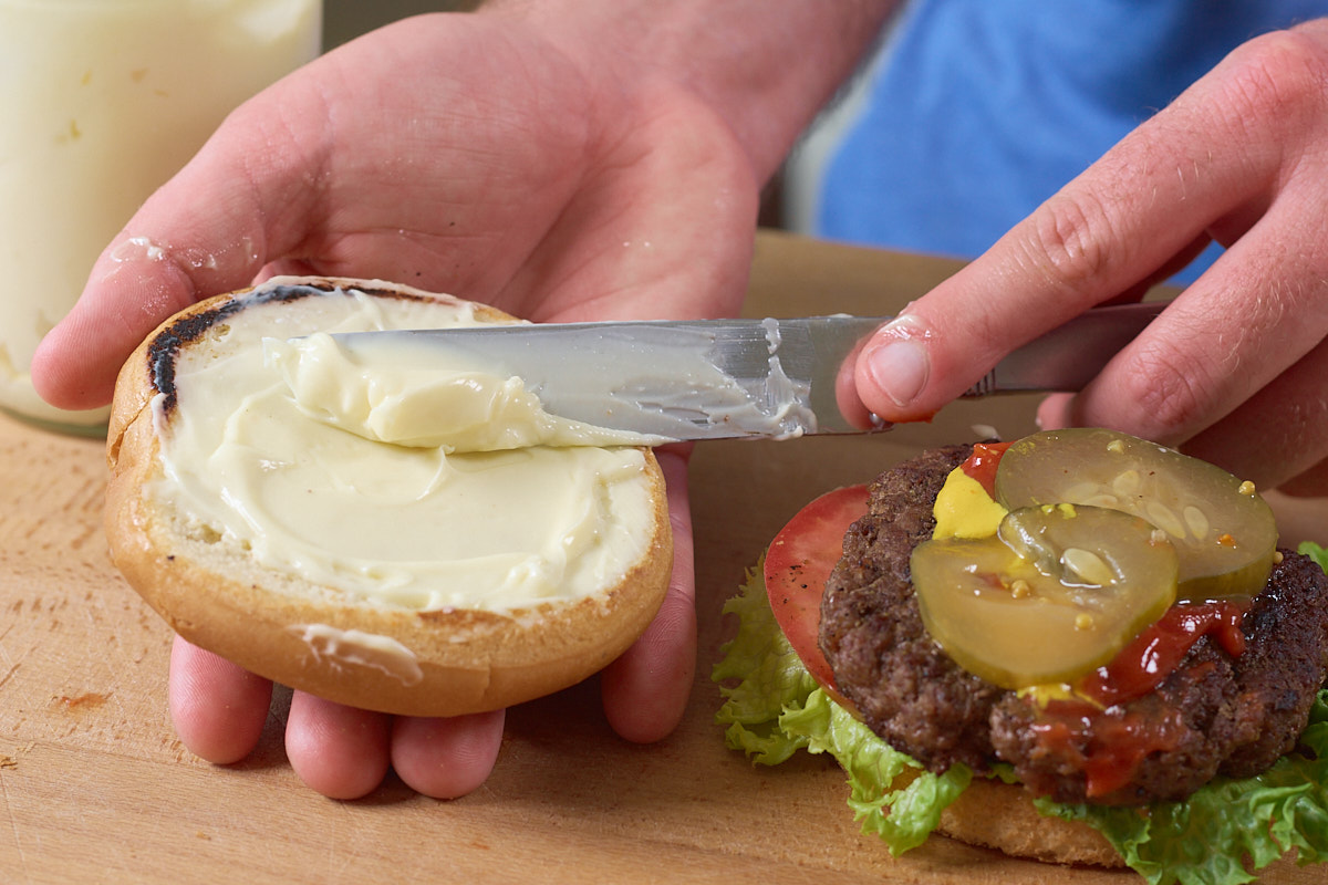 Spreading mayo on bun