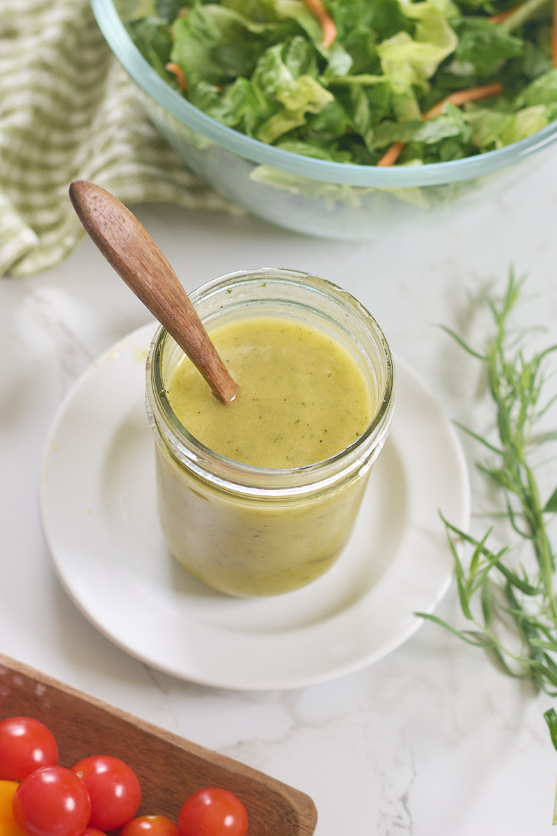 dressing in jar with spoon on plate