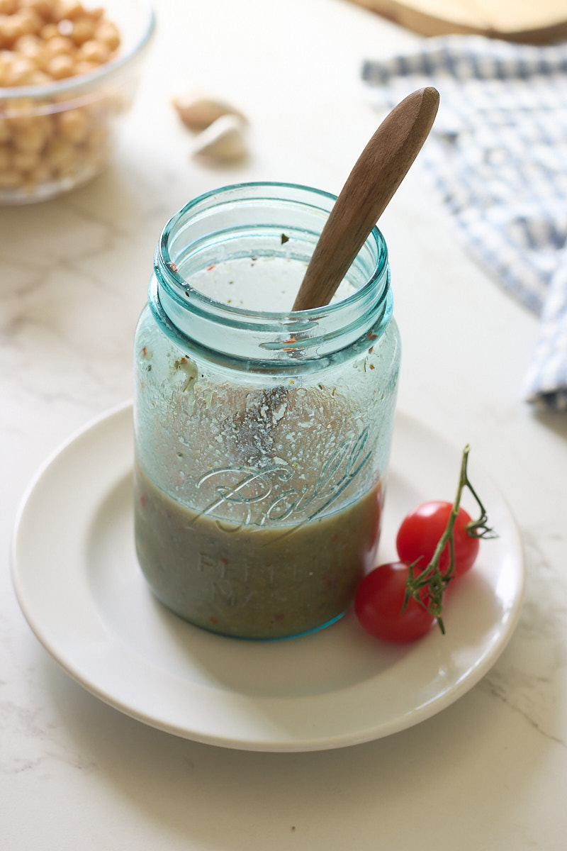 aquafaba dressing in jar with spoon