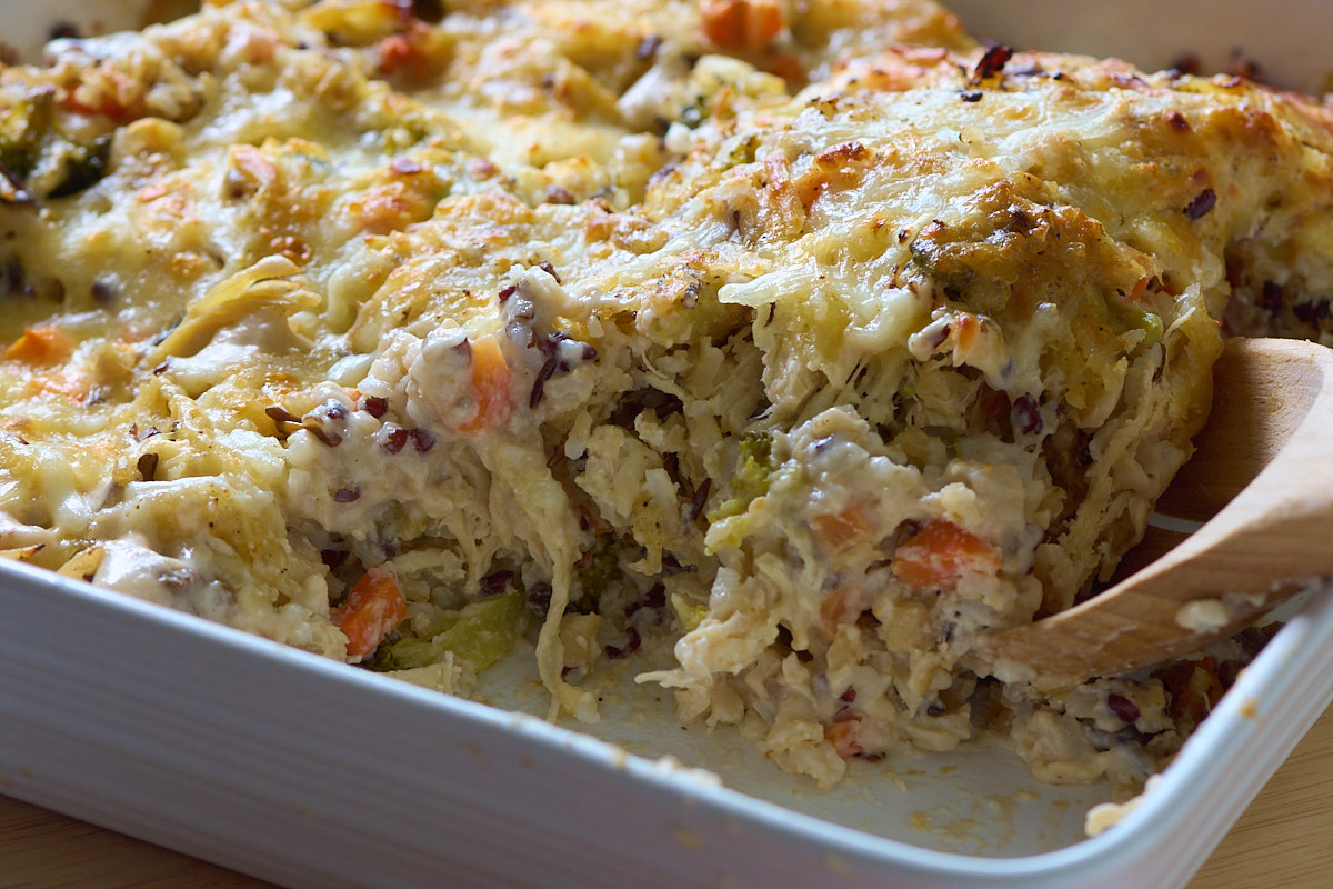 chicken and wild rice casserole with wooden spoon